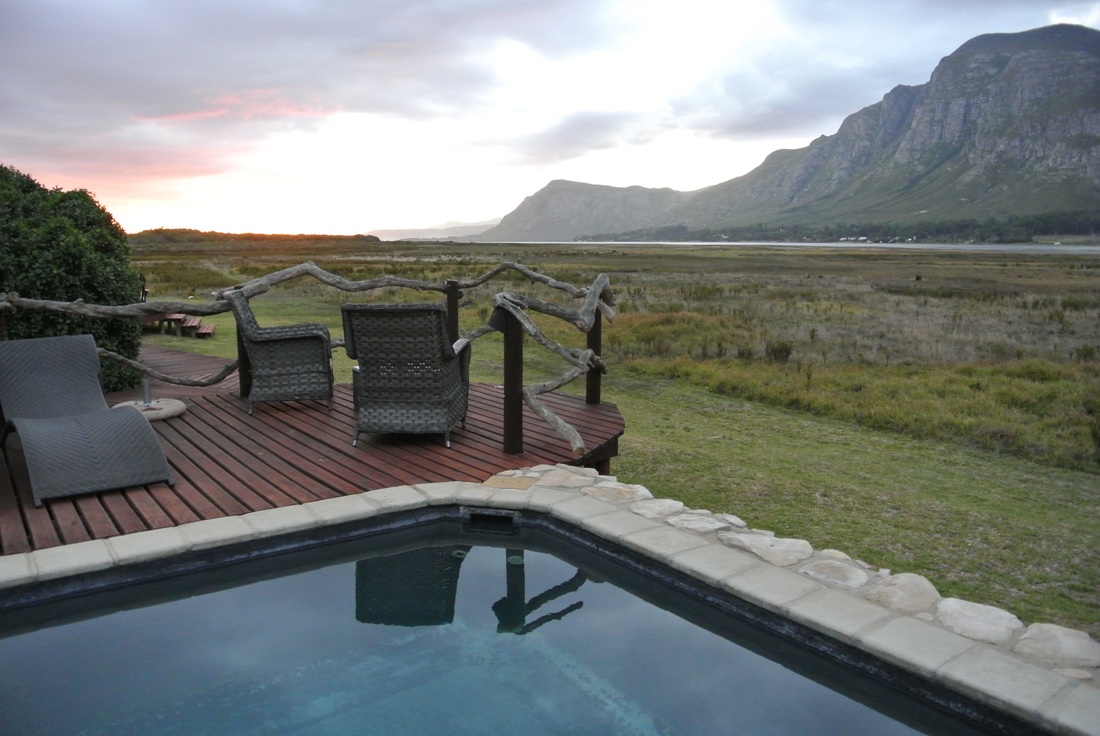 A heated outdoor plunge pool with seating area overlooking the most incredible vista